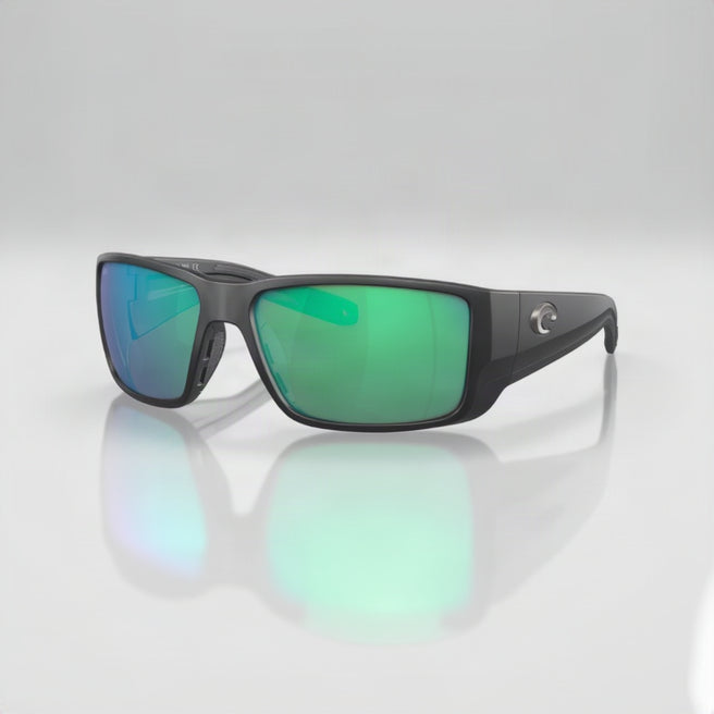 Sunglasses with green lenses and black frame on a white background